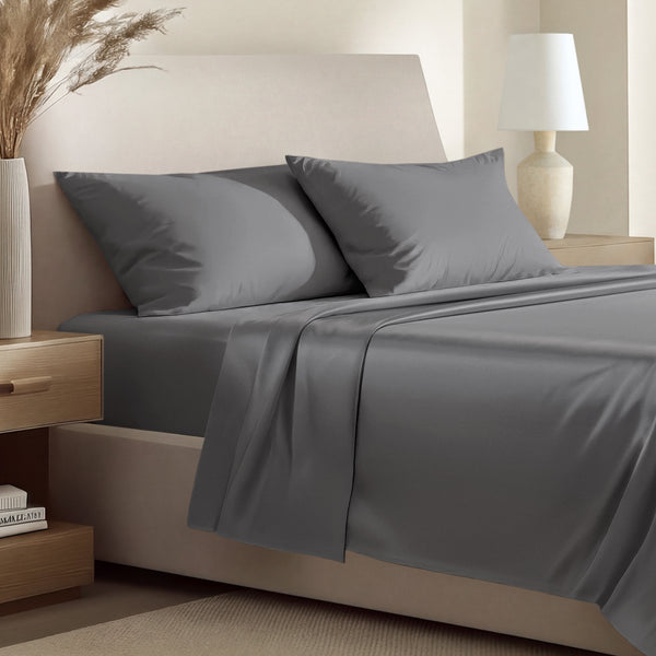 Sateen bedding set including a fitted sheet and two matching pillowcases on a bed.