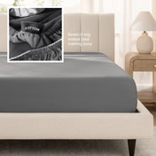 Bed with a fitted sheet next to a nightstand in a bedroom setting