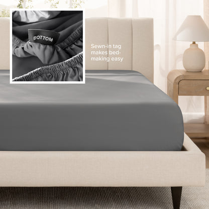 A fitted bed sheet shown on a bed. Text on the image says the sewn-in tag makes bed-making easy.