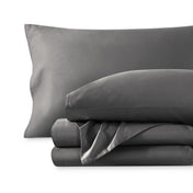 A sateen sheet set folded and stacked on a white background.