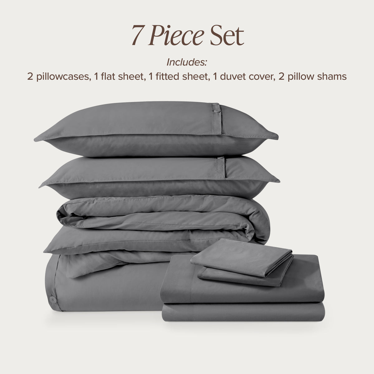 7-piece percale bedding set with pillowcases, flat sheet, fitted sheet, duvet cover, and pillow shams on a light background.
