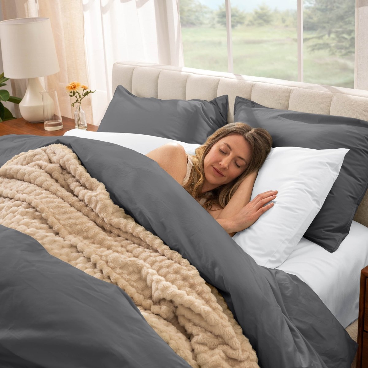Woman sleeping in a bed with percale bedding
