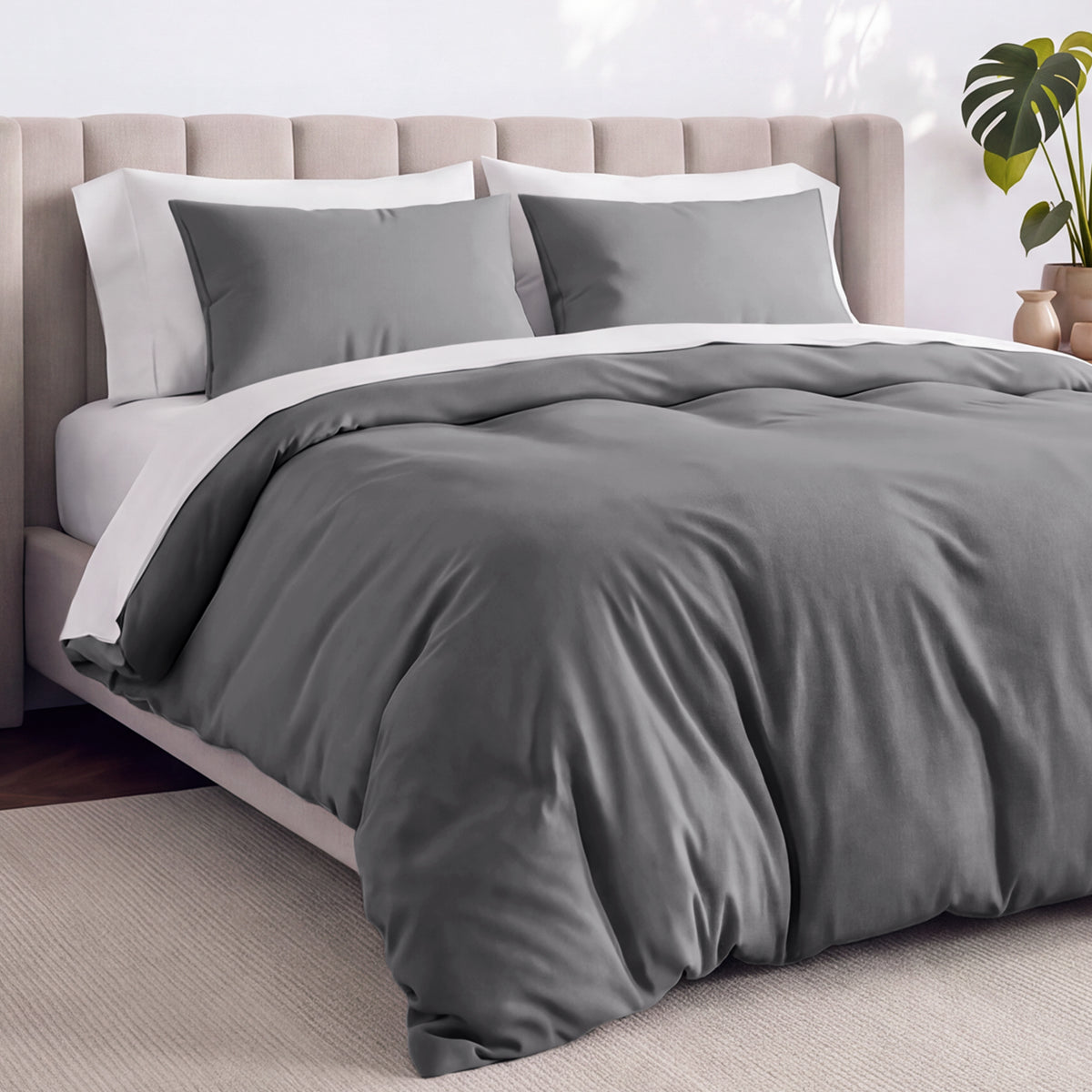 Bed with jersey duvet set against a beige headboard.
