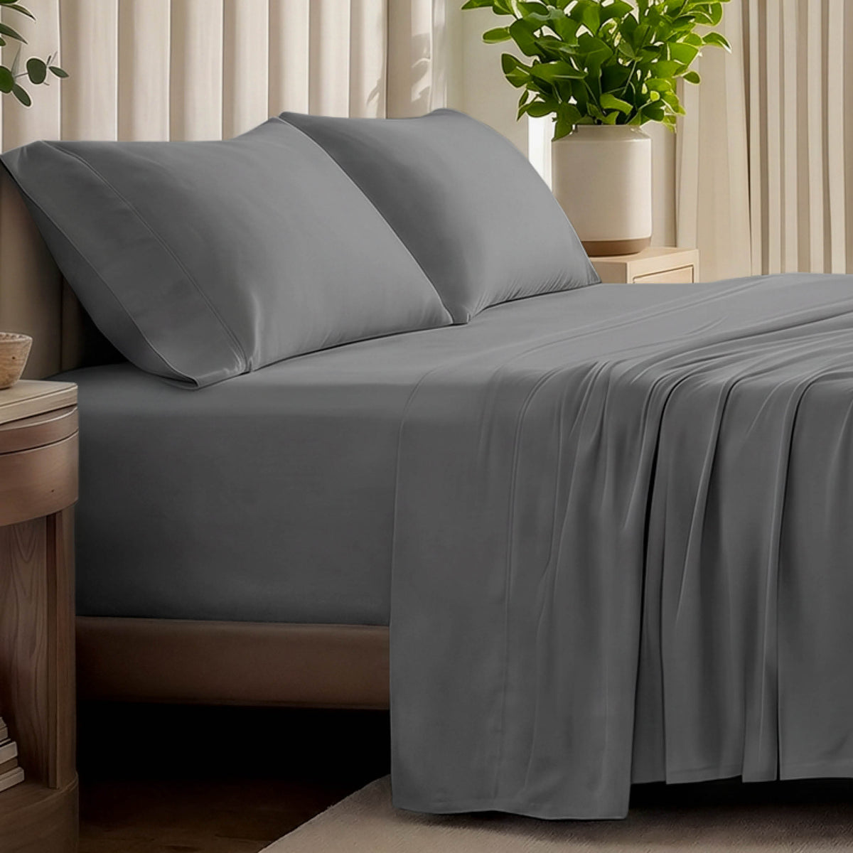 Organic jersey bed sheets and pillows on a bed with a wicker headboard.