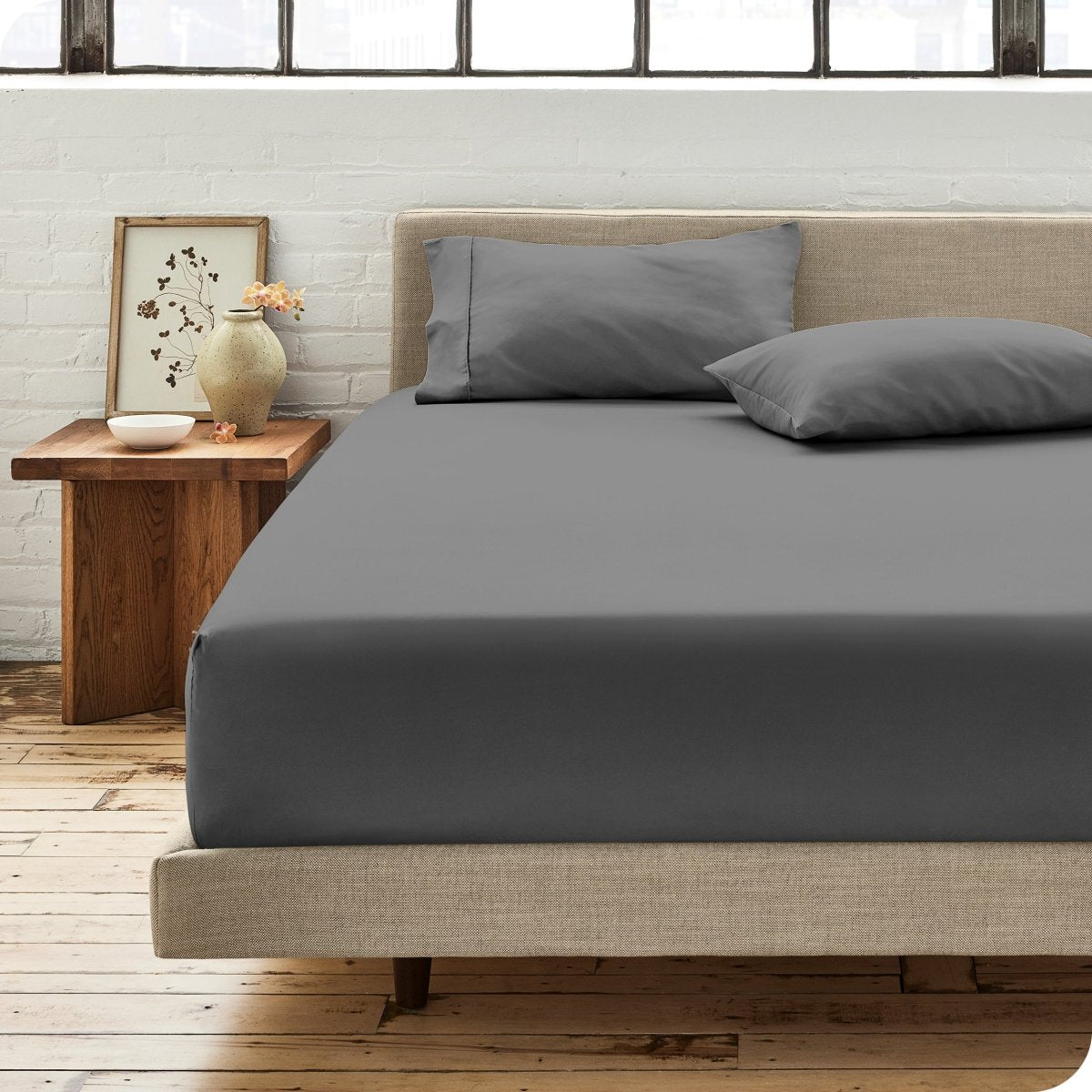 Modern bedroom with bed showing percale fitted sheet