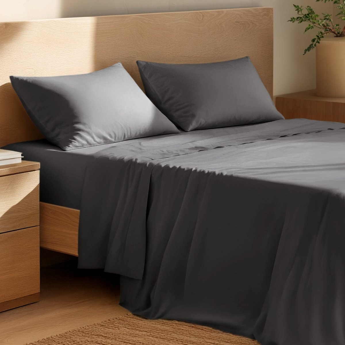 Bed with percale bedding and wooden headboard in a bedroom setting