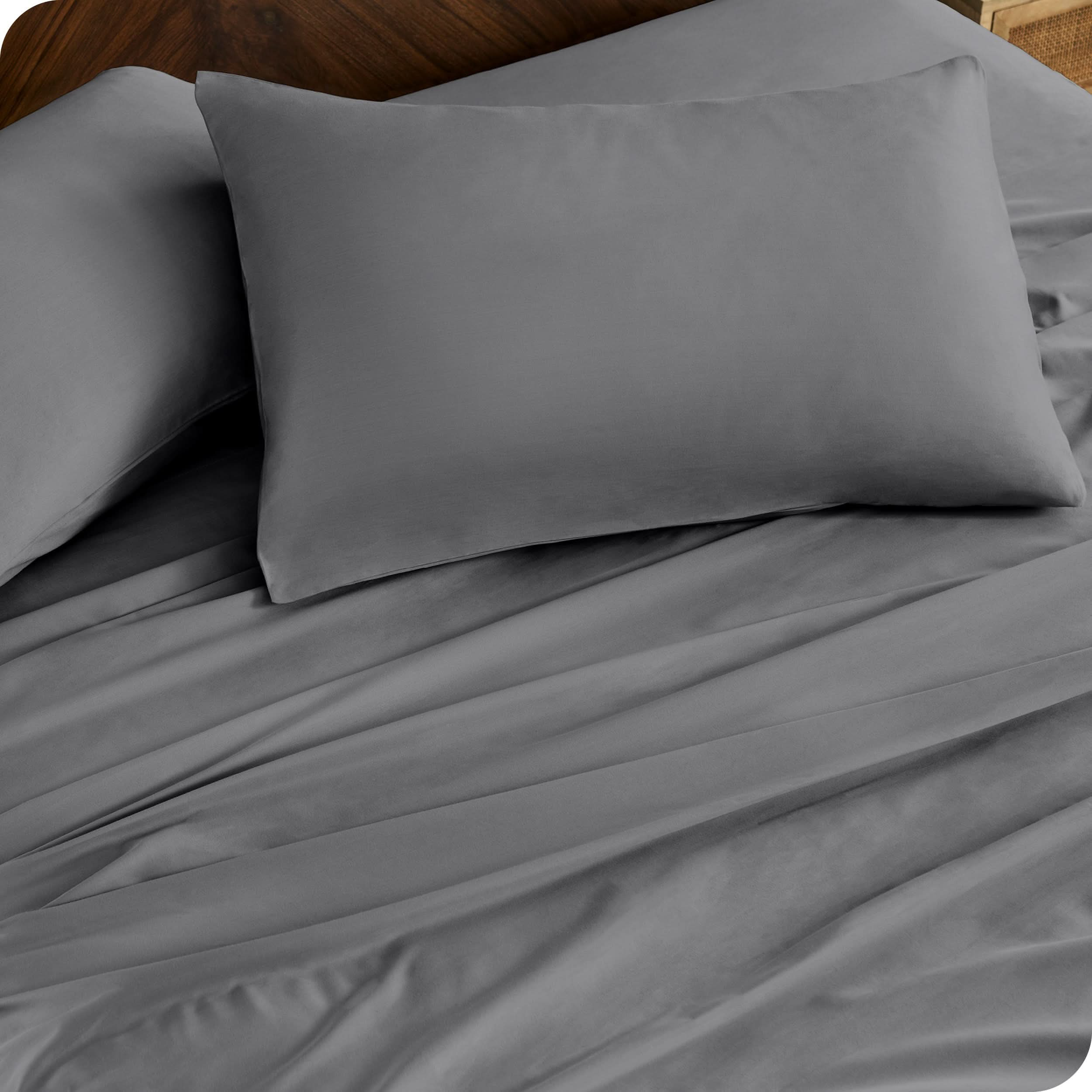 Close up of percale pillowcases and sheets on a bed