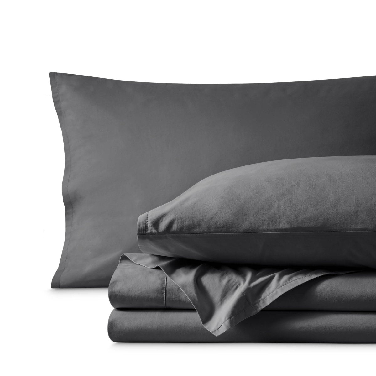 Percale bedding set including pillowcases and folded sheets arranged on a clean white background