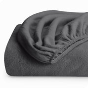 A folded polar fleece fitted sheet.