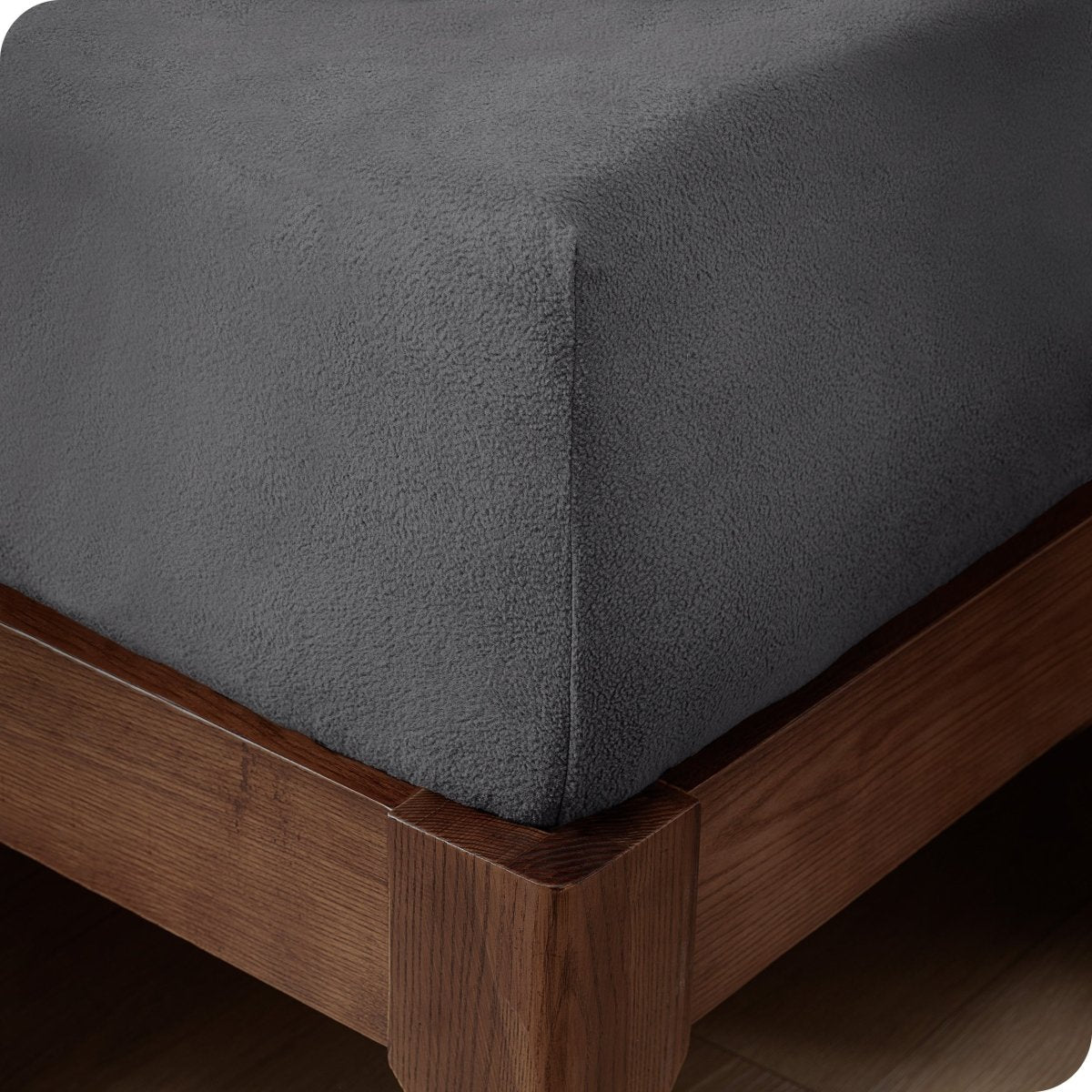 Close up of the corner of a mattress with a fleece fitted sheet on it