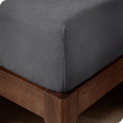 Close up of the corner of a mattress with a fleece fitted sheet on it
