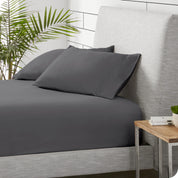 A sideview of a modern bed with a polar fleece fitted sheet on.