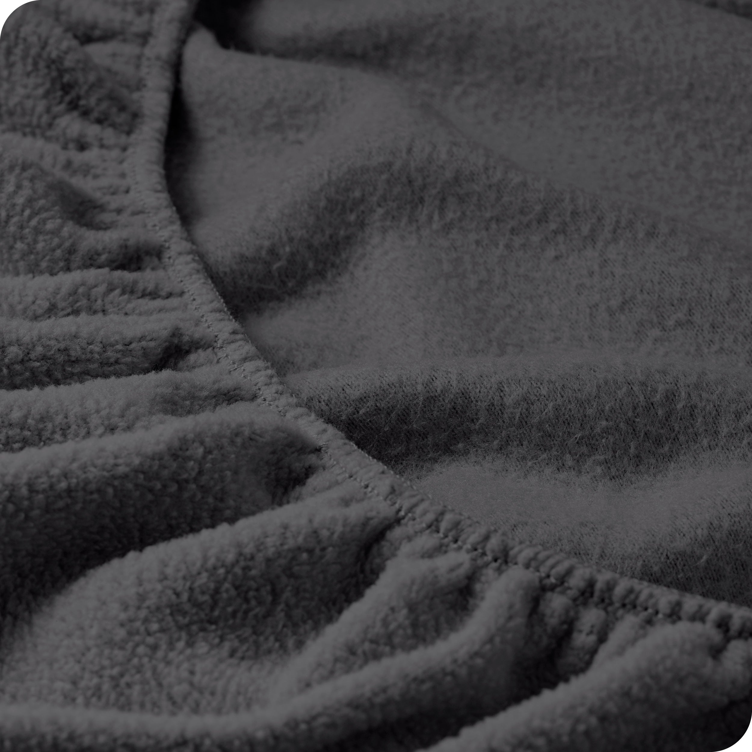 A close view of the elastic of a polar fleece fitted sheet.