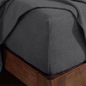 Corner of a mattress with a fitted sheet on it