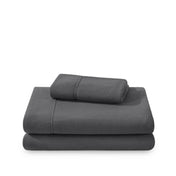 Polar fleece sheets and pillowcases folded and stacked on a white background