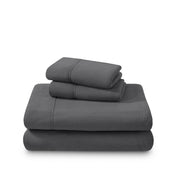 Polar fleece sheets and pillowcases folded and stacked on a white background