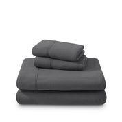 Polar fleece sheets and pillowcases folded and stacked on a white background