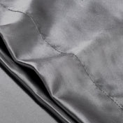 Close-up of the envelope closure on the satin pillowcase