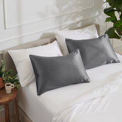 Satin pillowcases on a bed with white bedding
