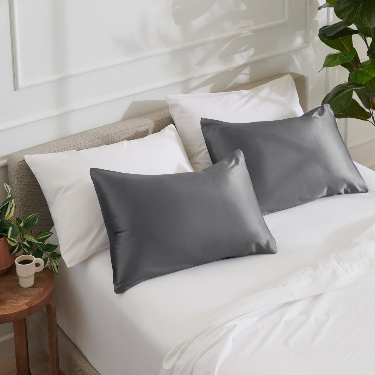 Satin pillowcases on a bed with white bedding