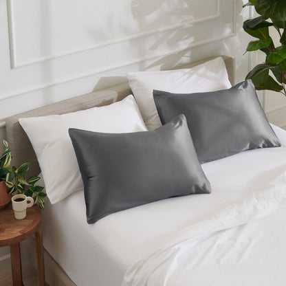 Satin pillowcases on a bed with white bedding