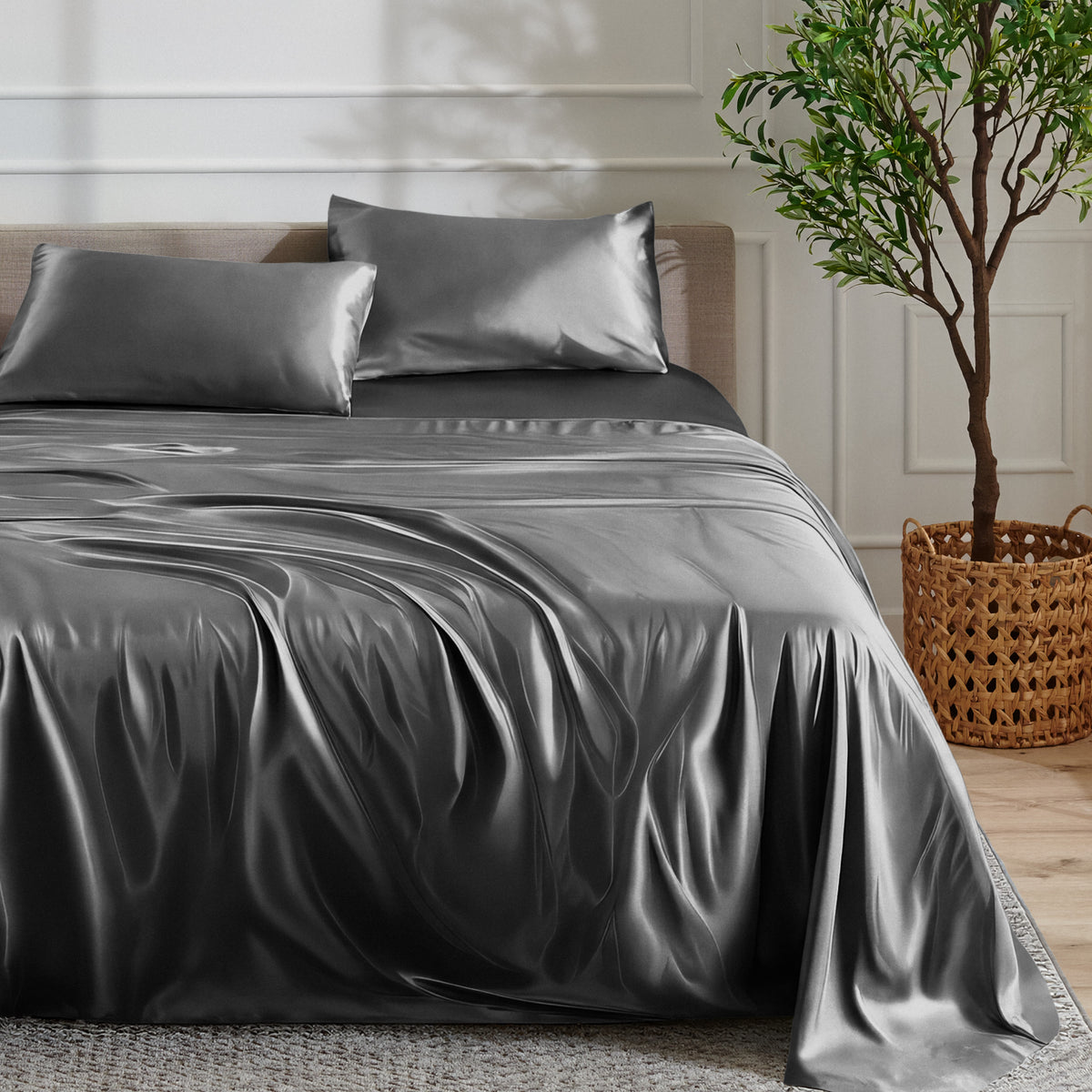 Satin sheet set on a bed with a plant and basket in the background