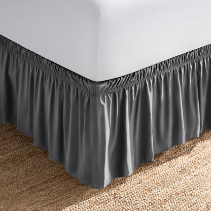 Bed with white fitted sheet and an adjustable bed skirt.