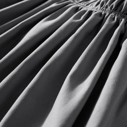 Close-up of polyester bed skirt fabric with a focus on texture and folds.