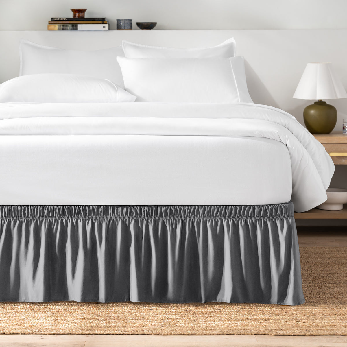 Bed with white bedding and a bed skirt.