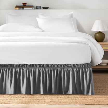 Bed with white bedding and a bed skirt.