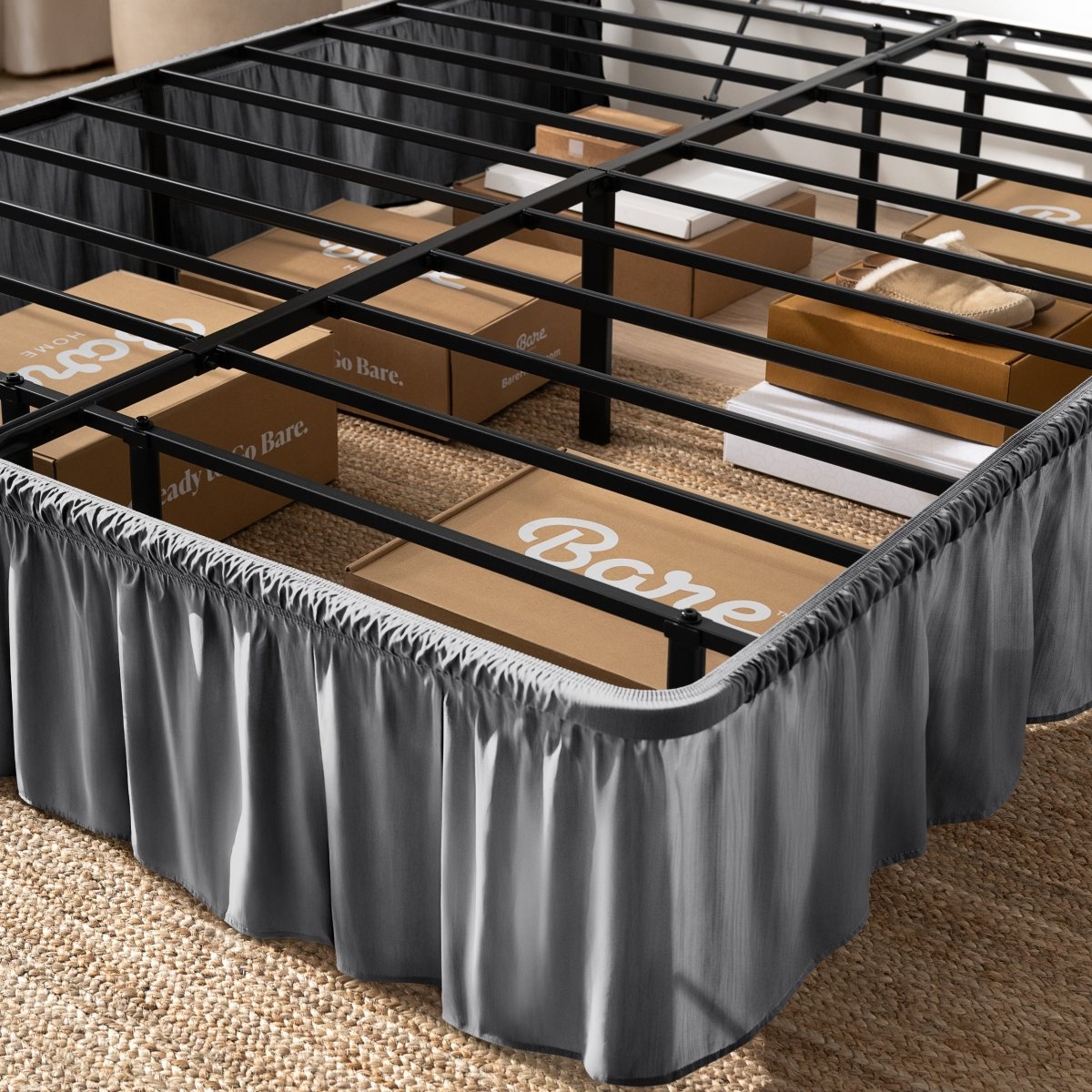 Bed frame with bed skirt and Bare Home boxes underneath.