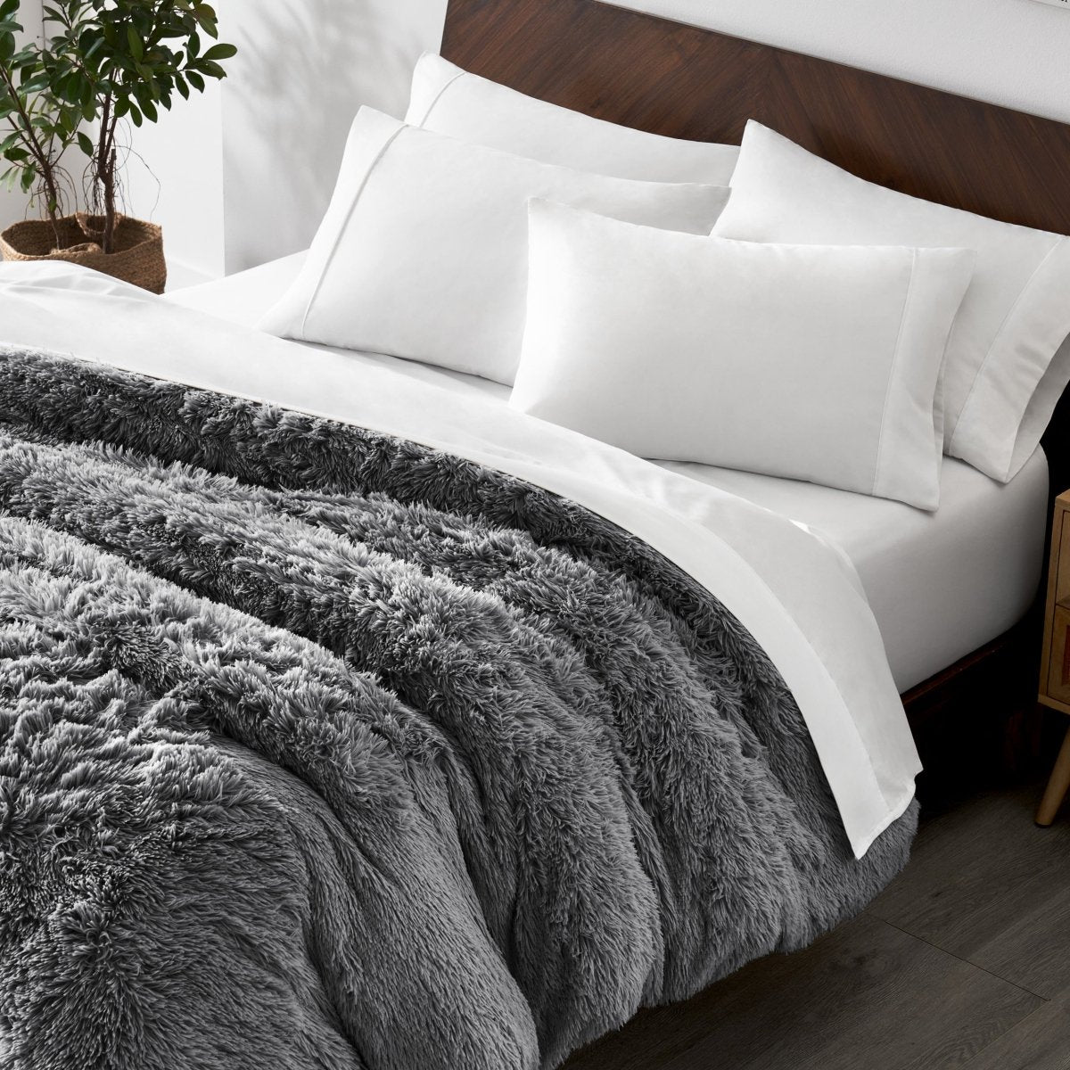 Shaggy duvet cover on a bed with white pillows and a wooden headboard.