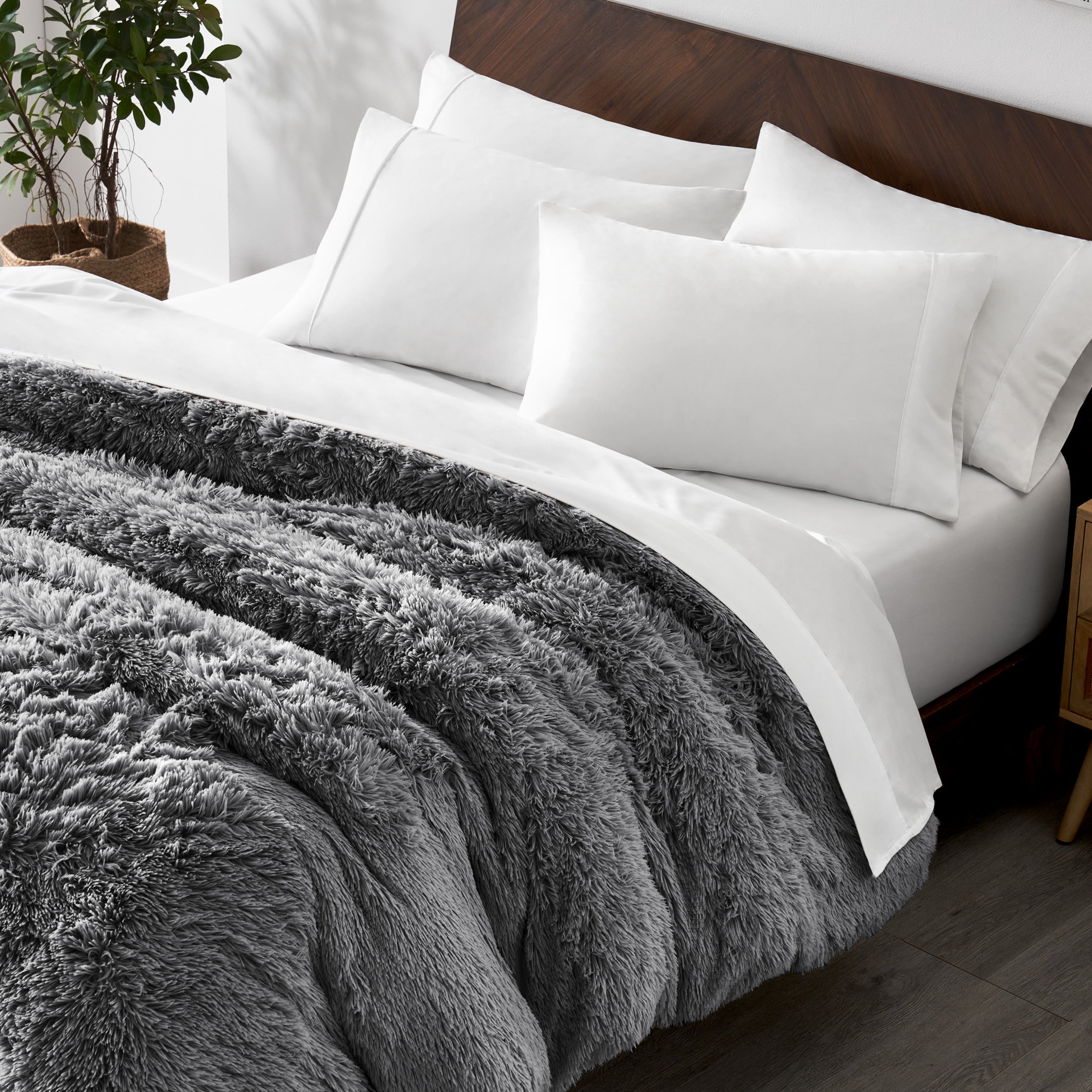 Shaggy duvet cover on a bed with white pillows and a wooden headboard.