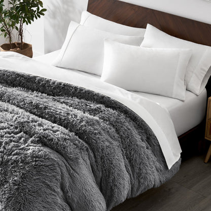 Shaggy duvet cover on a bed with white pillows and a wooden headboard.