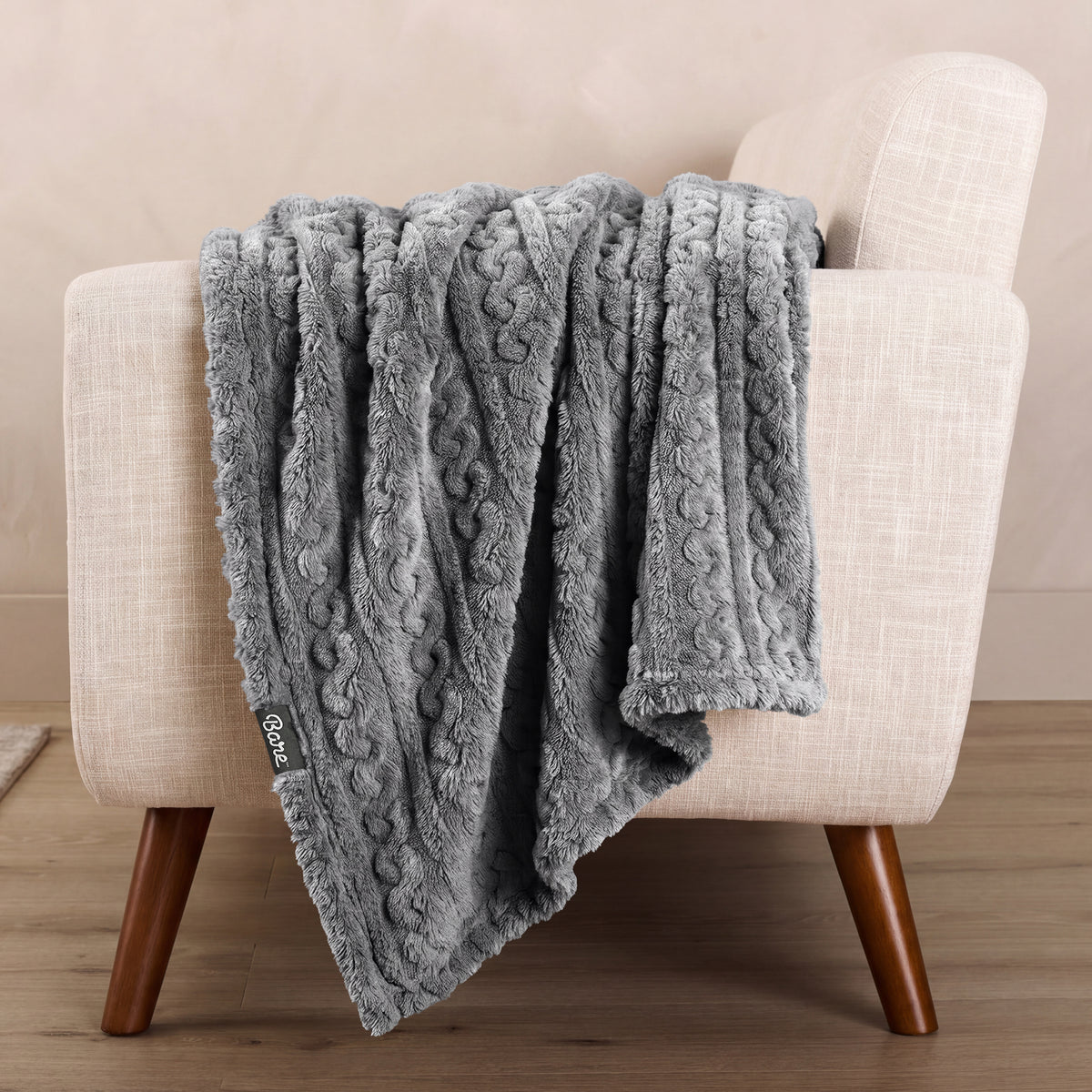 A textured blanket draped over a chair