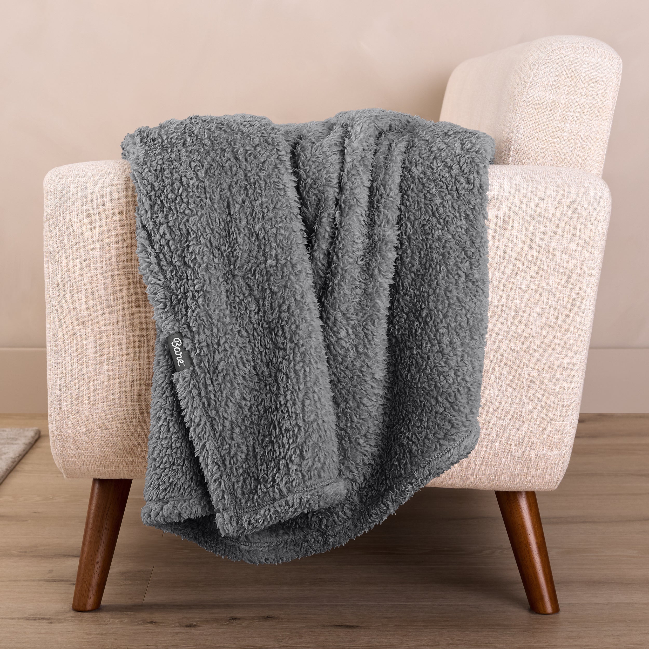 A sherpa blanket draped over a chair