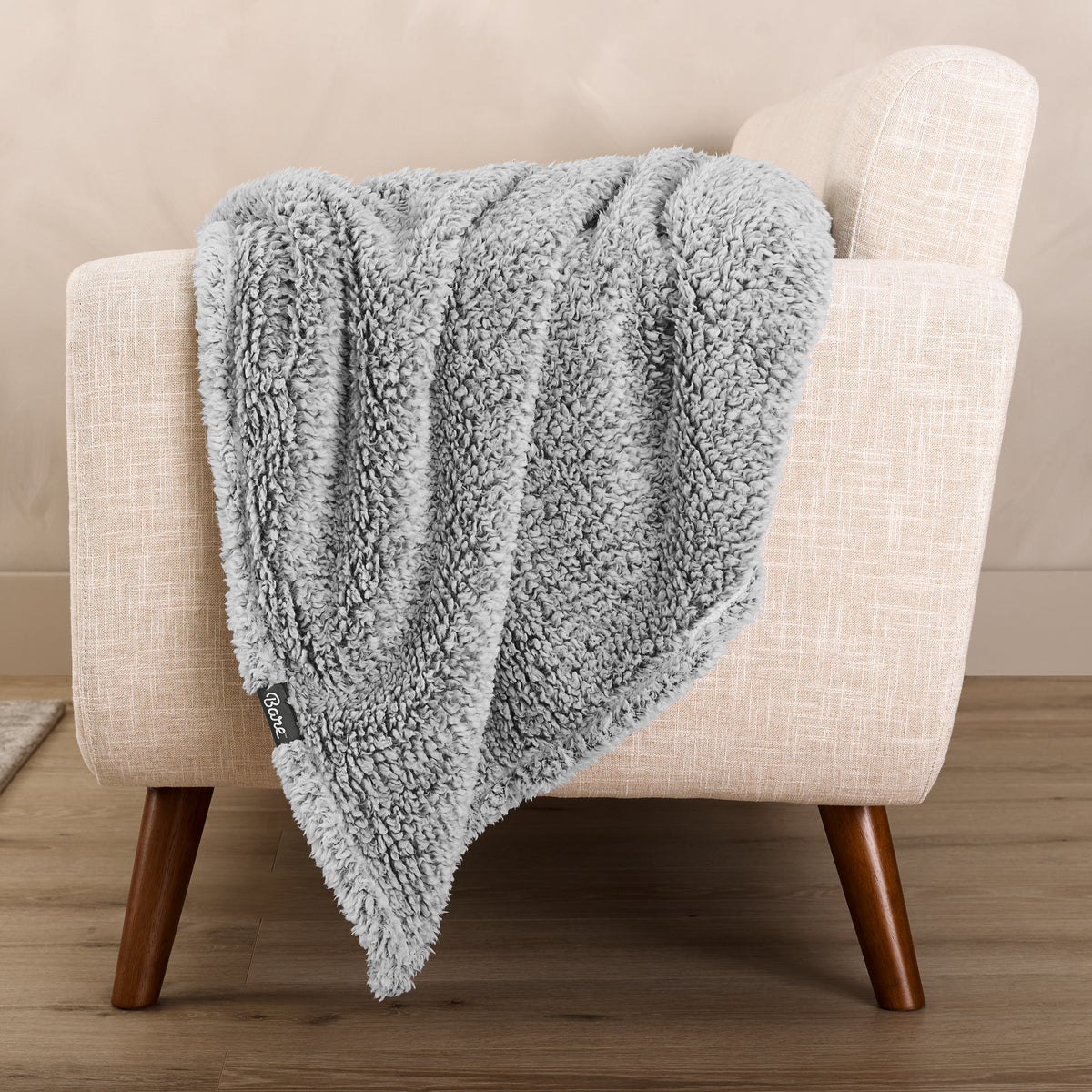 A textured blanket draped over a chair