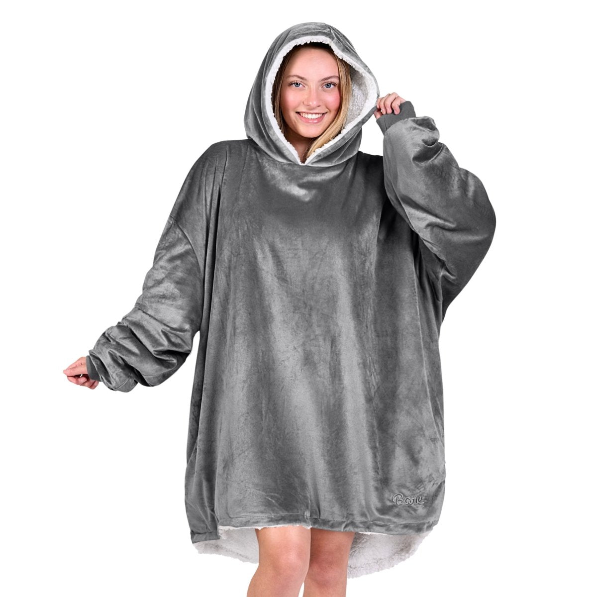 An adult with a hooded wearable blanket on