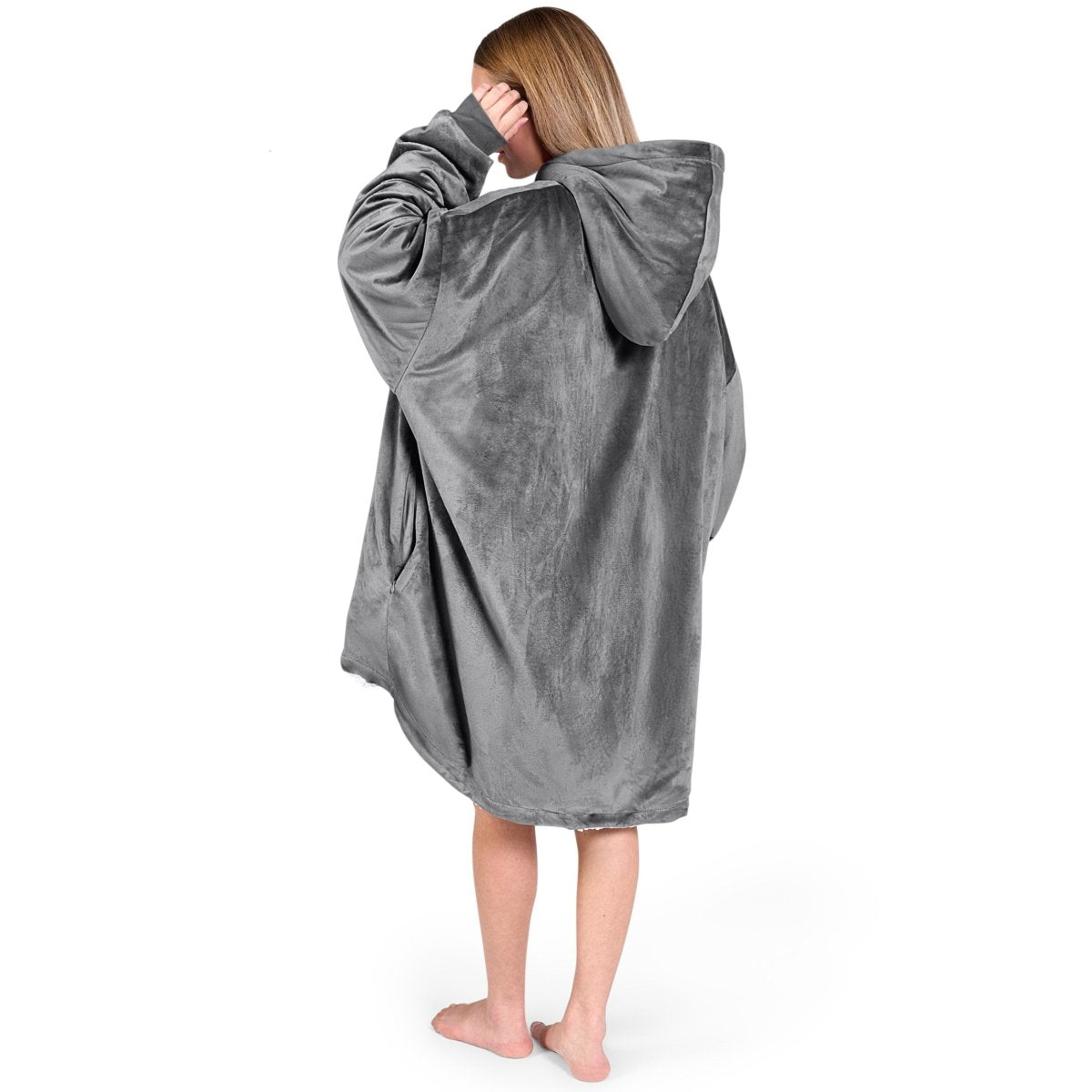 An adult with a sherpa wearable blanket on