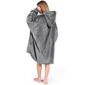 An adult with a sherpa wearable blanket on