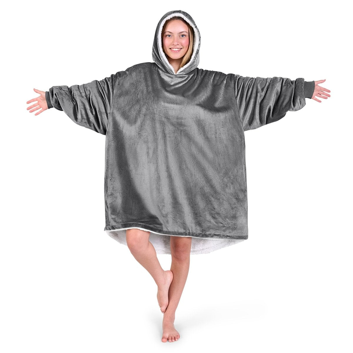 An adult with a hooded wearable blanket on