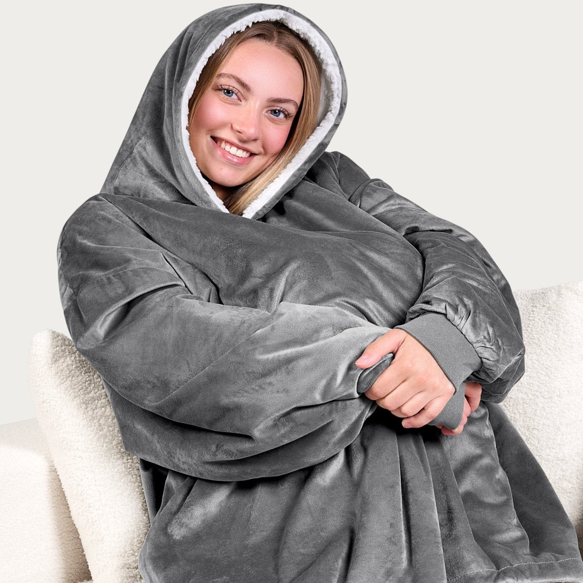 An adult with a sherpa wearable blanket on