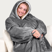 An adult with a sherpa wearable blanket on
