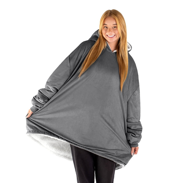 An adult with a sherpa wearable blanket on