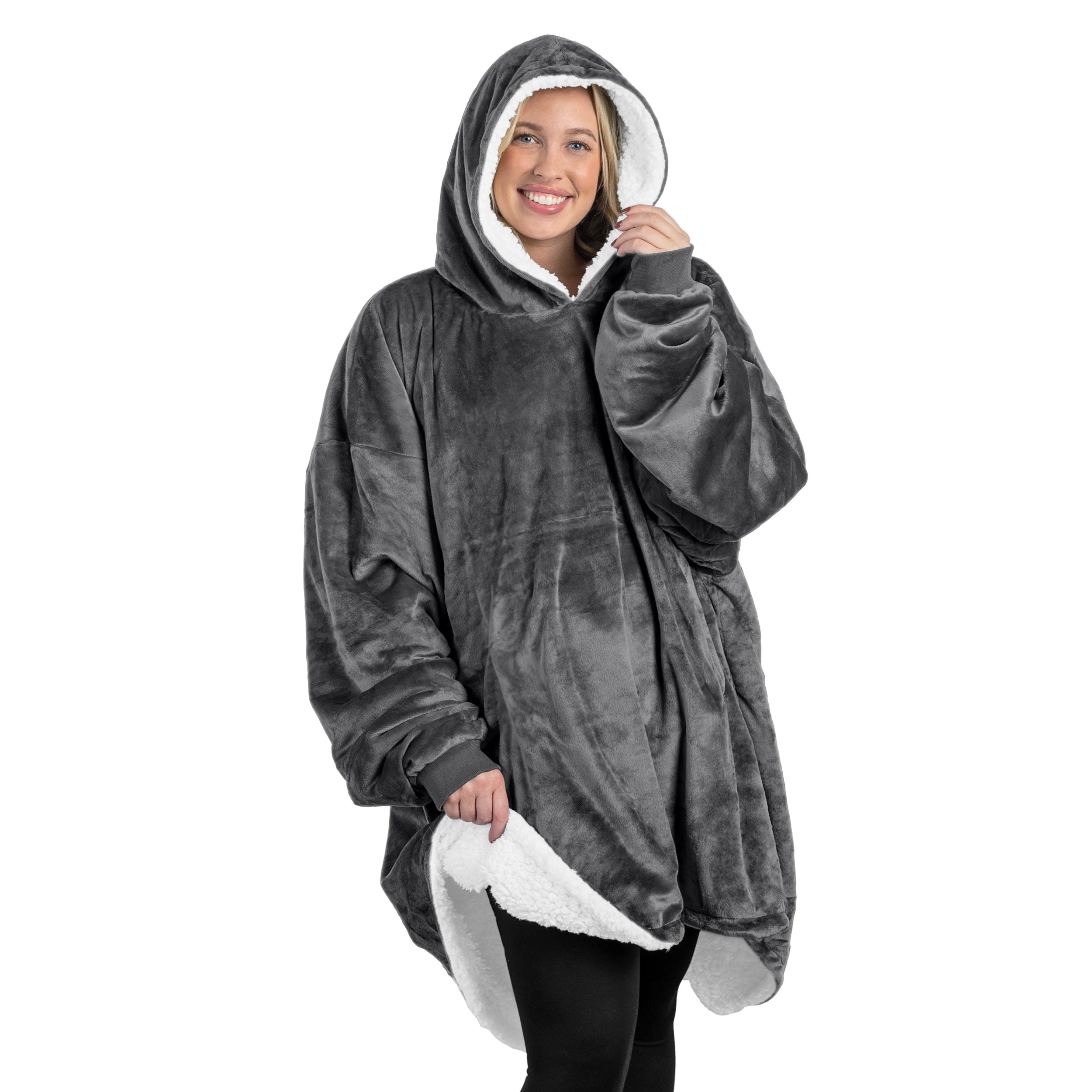 A oversized sherpa wearable blanket with a hood on a woman.