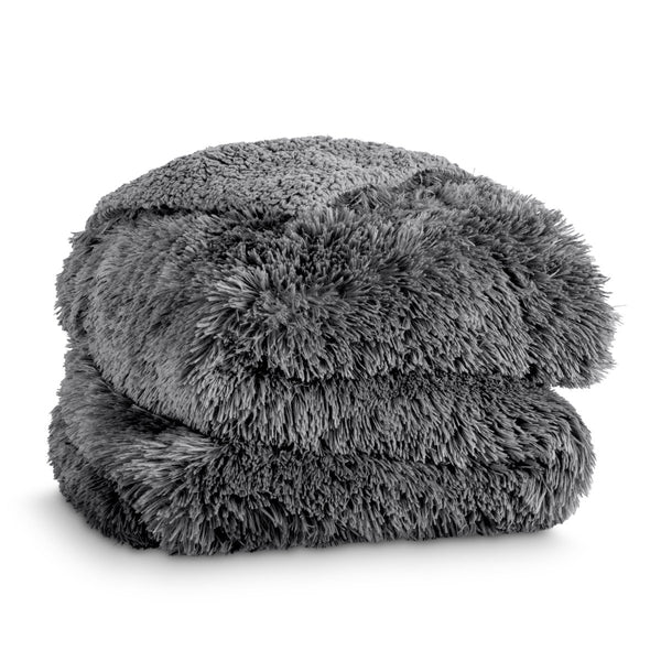 A shaggy faux fur blanket folded