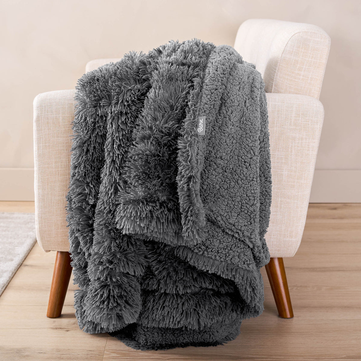 A shaggy blanket draped over the arm of a chair