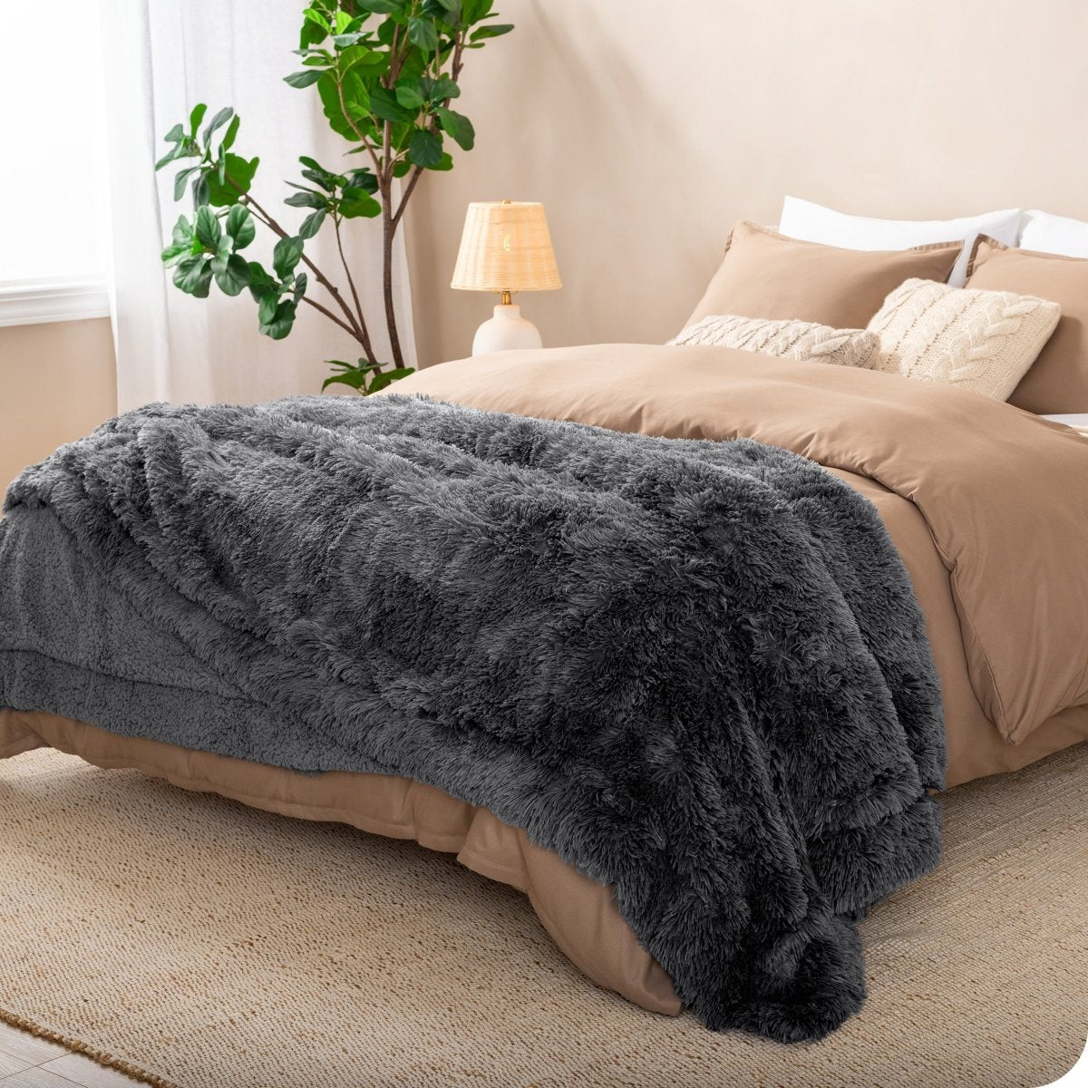 A shaggy faux fur blanket on the end of a bed