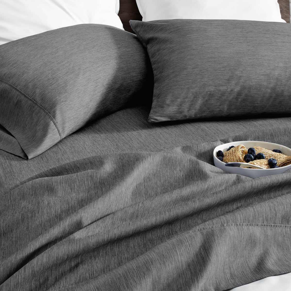 Ultra soft sheet set with a bowl of food on a bed