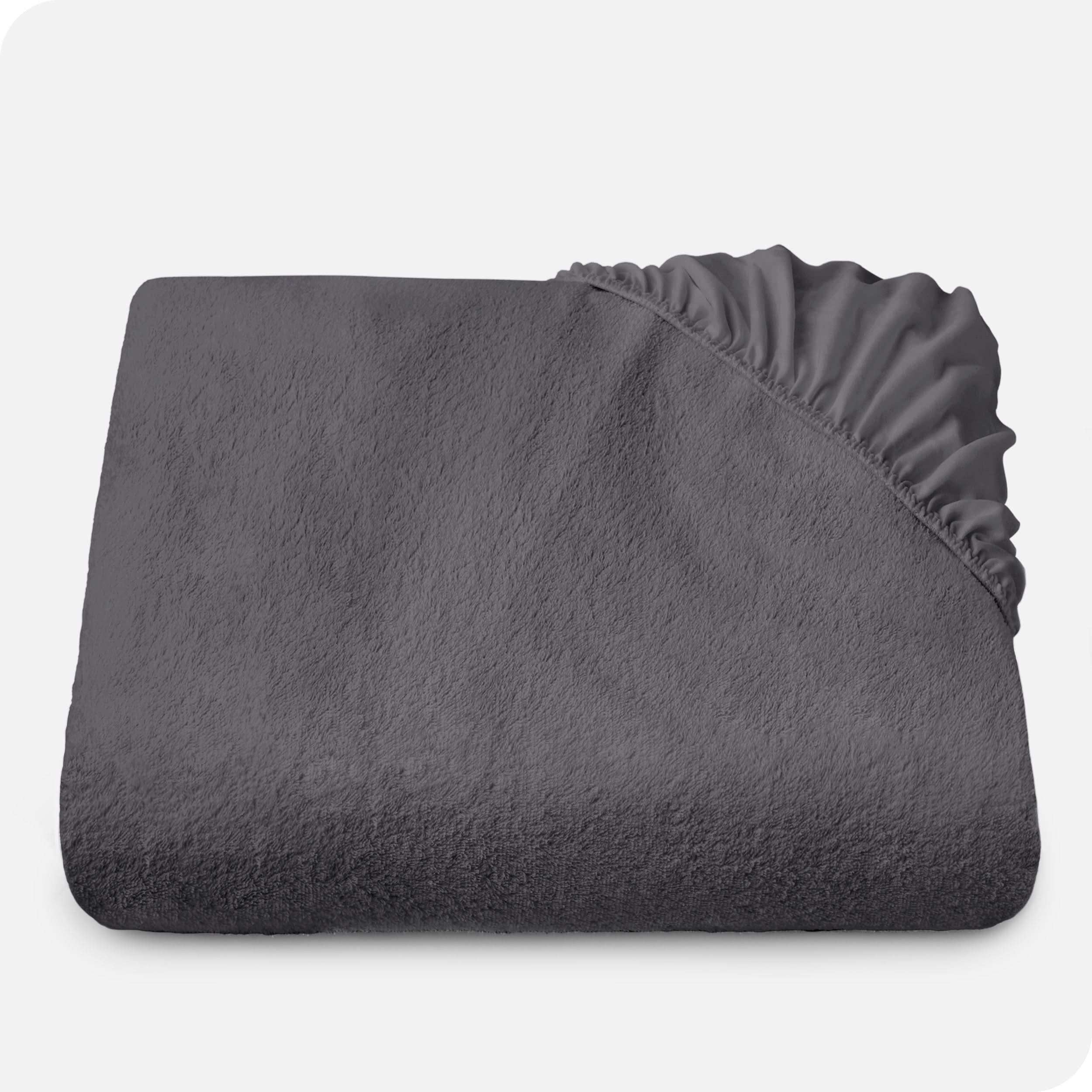 Terry mattress protector folded neatly with the elastic from a corner folded over the top